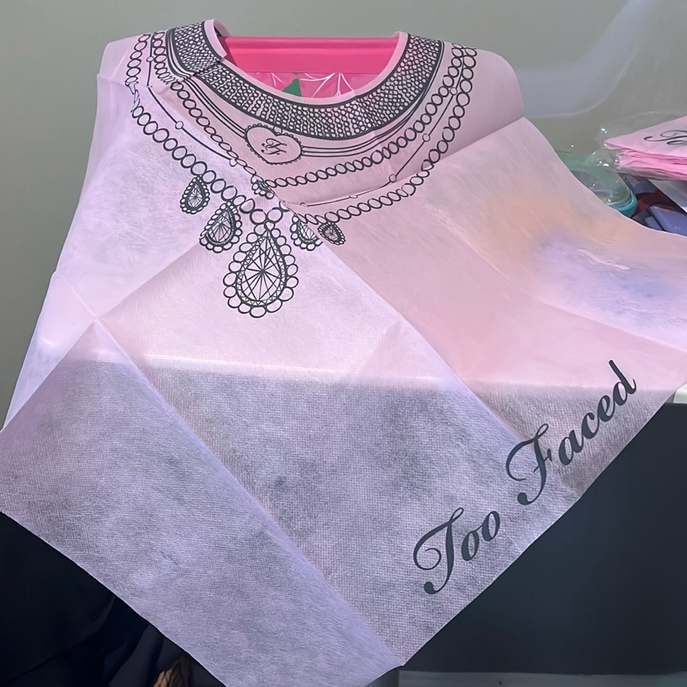 Too Faces disposable makeup bibs. I have 2 packages of 10 bibs each.